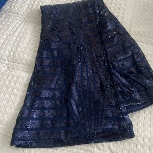 Navy blue sequin flare pants with pattern.